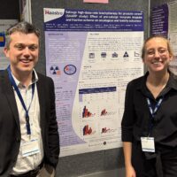 Evert van Limbergen en Iris Laven poseren voor een poster die ze tijdens de EMUC 2025 presenteren